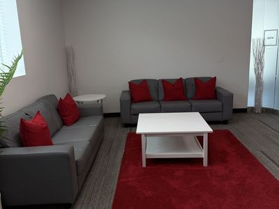 Living Room set with 2 Modern Gray Faux Leather Sofa Set with Red Accent Pillows, side table, coffee table, and rug