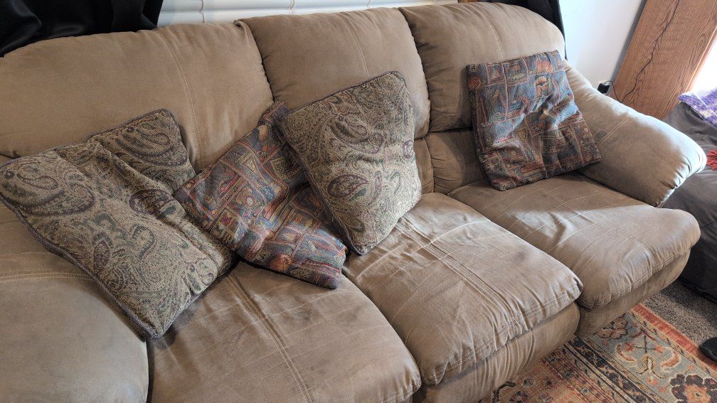 Comfortable Tan Queen Sleeper Sofa with Patterned Throw Pillows - Used Good Condition