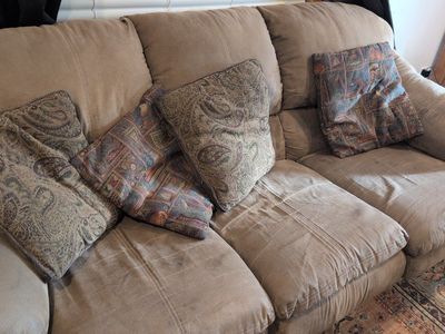 Comfortable Tan Queen Sleeper Sofa with Patterned Throw Pillows - Used Good Condition