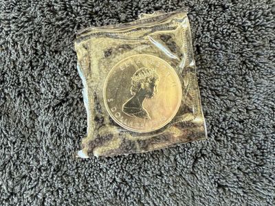 1988 Elizabeth II One Dollar Coin - Uncirculated in Protective Sleeve. Canadian Maple Leaf
