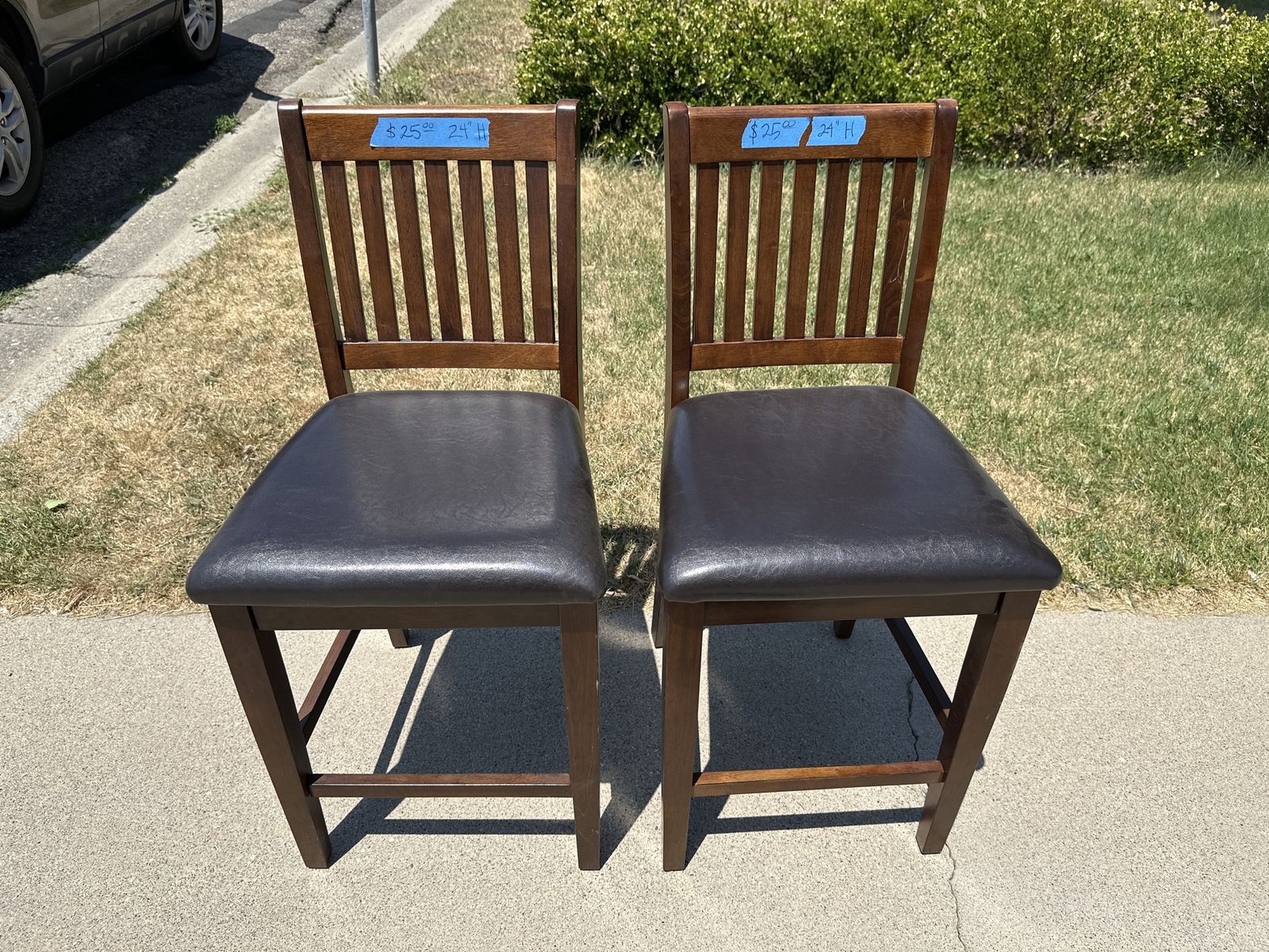 2 Brown Wood Bar Stools / Counter Height Chairs with Padded Black Faux Leather Seats - 24" H