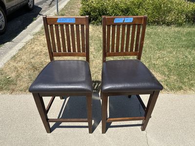 2 Brown Wood Bar Stools / Counter Height Chairs with Padded Black Faux Leather Seats - 24" H