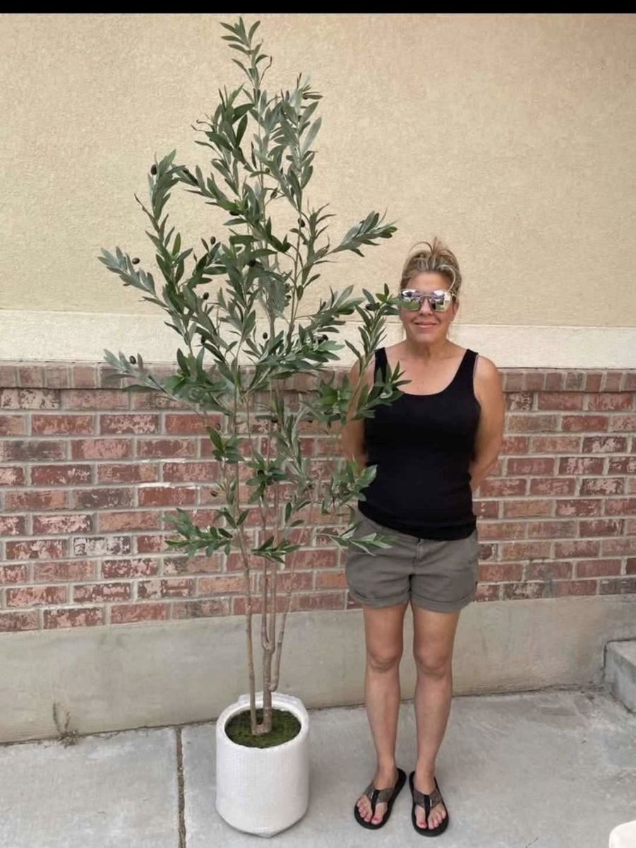 New. Nearly natural 7 foot olive tree. White pot not included. It does come with a black pot.
