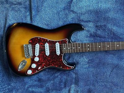 Squier by Fender Stratocaster Electric Guitar Sunburst with Red Tortoiseshell Pickguard and Guitar Case