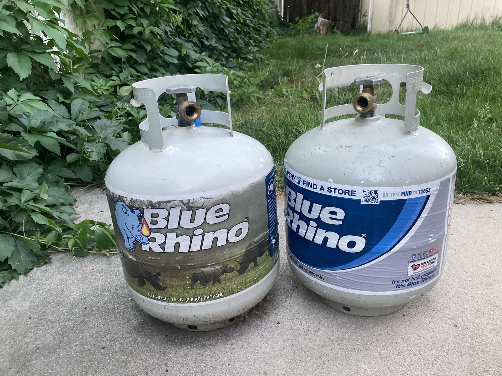 Two 15 lb Blue Rhino Propane Tanks — One Half Full, One Empty