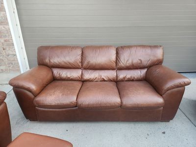 Leather couch, chairs, and ottomans