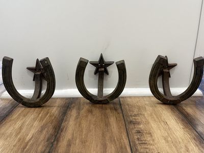 Three rustic western horseshoe coat racks.