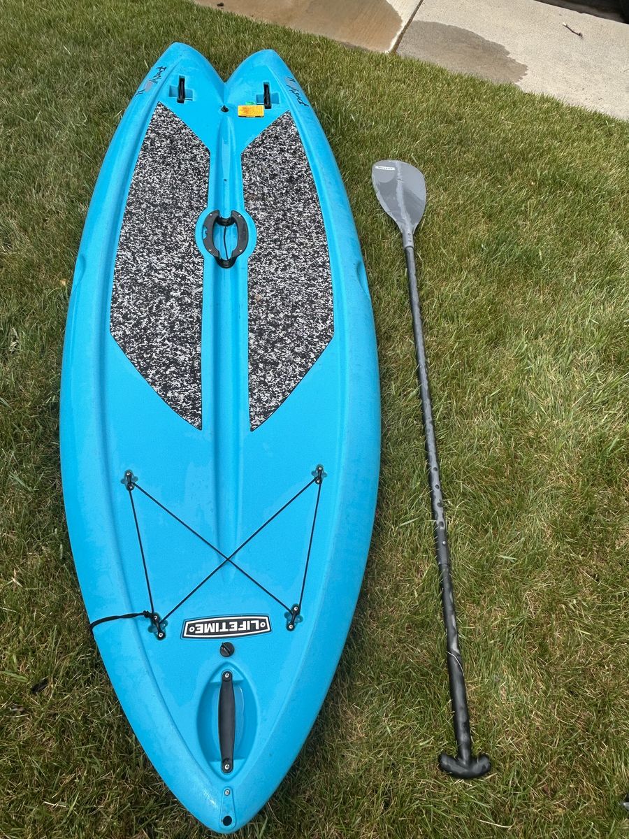 Blue lifetime paddleboard with fold up fins and adjustable paddle