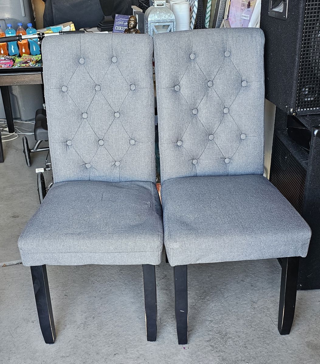 Gray fabric, upholstered tufted dining chairs with Black Legs.  Been a little beat up, but still work.