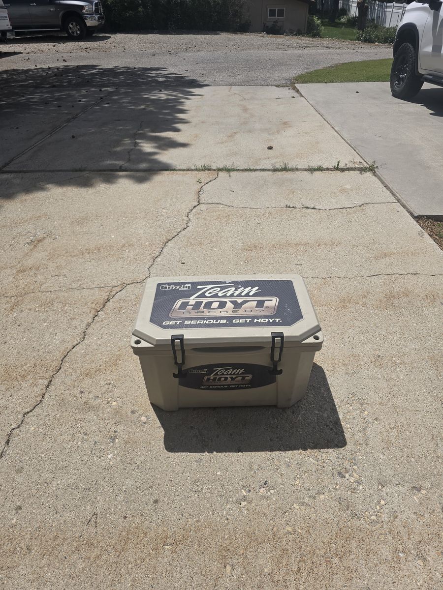 Two coolers, Grizzly 45 team Hoyt archery and an Igloo Maccold premium 62q