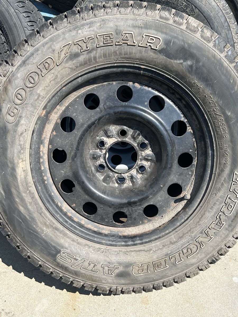 Goodyear Wrangler AT/S LT275/65R18 Tire on Black Steel Wheel Rim