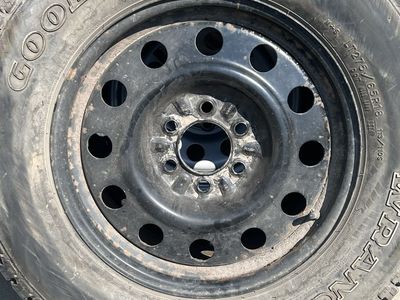 Goodyear Wrangler AT/S LT275/65R18 Tire on Black Steel Wheel Rim