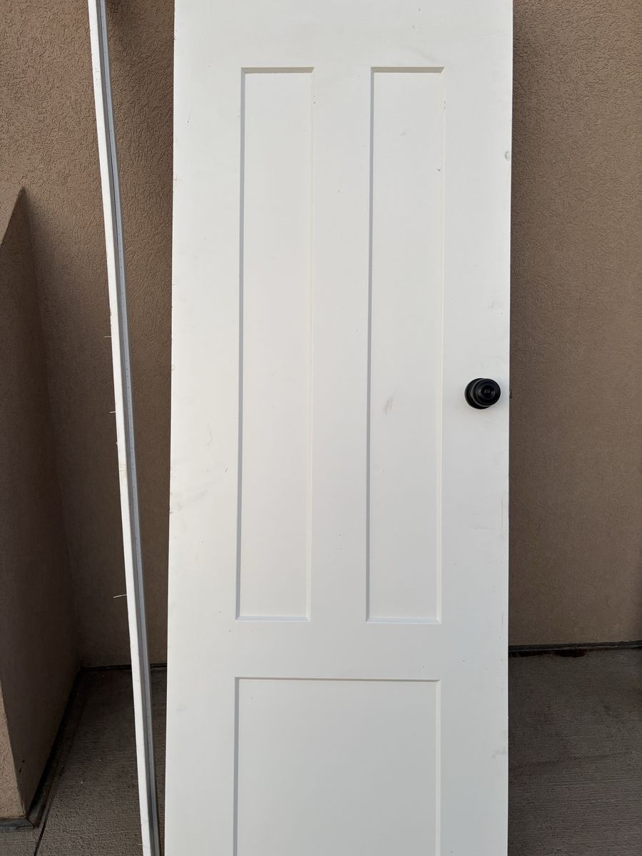 White 3-Panel Interior Door with Black Doorknob