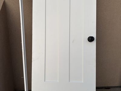 White 3-Panel Interior Door with Black Doorknob