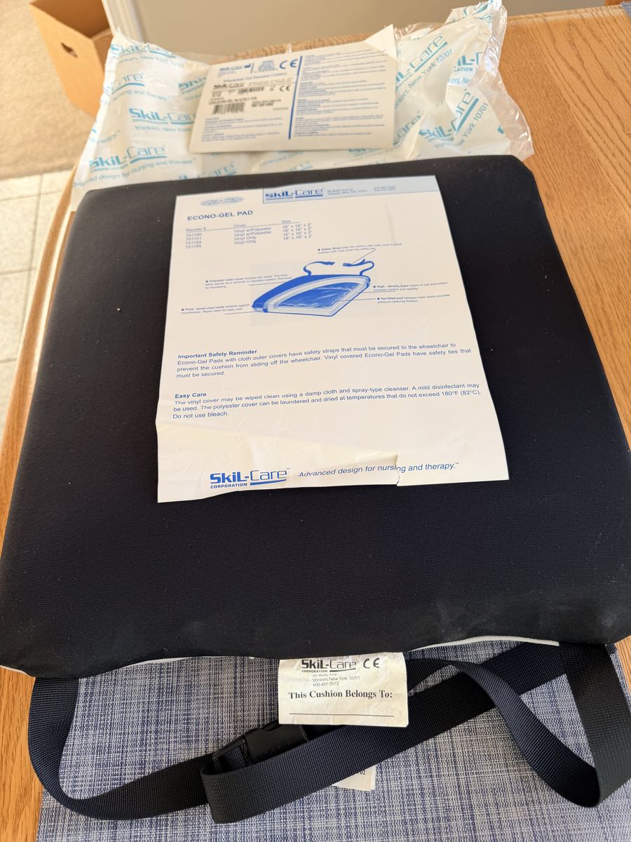 This Skil-Care Econo-Gel Wheelchair Cushion features a black low-shear cover and a two-part gel pod design for pressure relief.