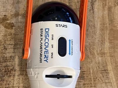 Discovery Star Planetarium Star Projection Light with Orange Handle