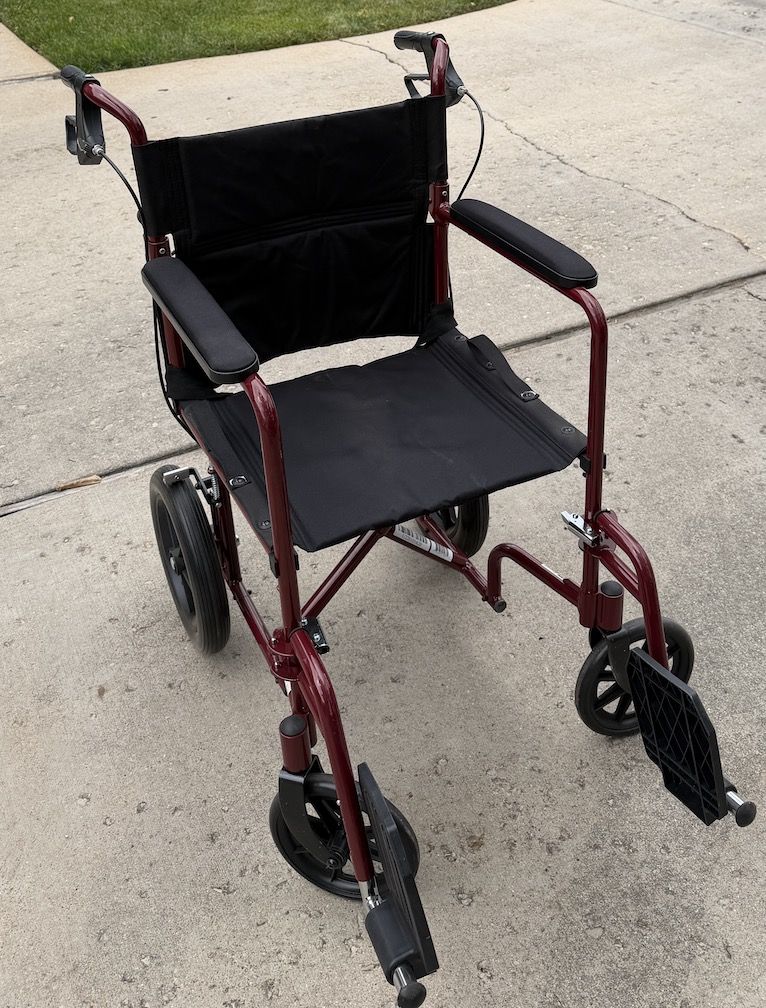 Medline Lightweight Foldable Transport Wheelchair with Handbrakes and 12-Inch Wheels, Red Frame, Black Upholstery