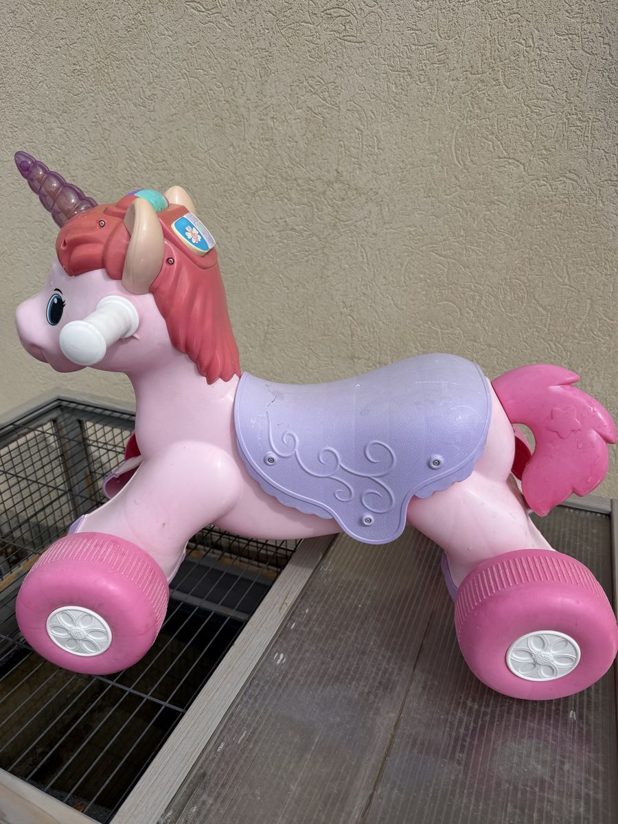 Pink Unicorn Ride-On Toy with Handlebars and Wheels