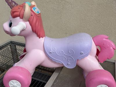 Pink Unicorn Ride-On Toy with Handlebars and Wheels