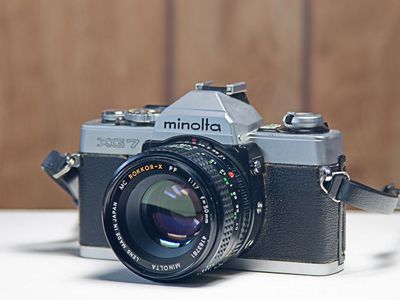 Minolta XG-7 w/Minolta 50mm f?1.7 MC Rokkor-X PF Lens. 55mm Filter Thread, No Cap, Thin Plastic Strap