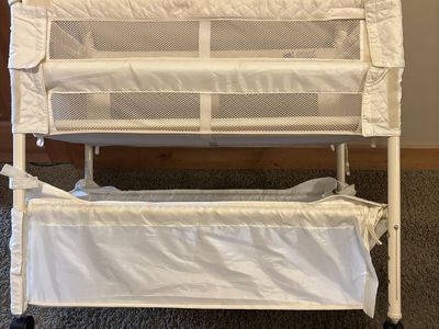 Portable Creamy White Mesh Baby Bassinet with Storage Basket and Caster Wheels