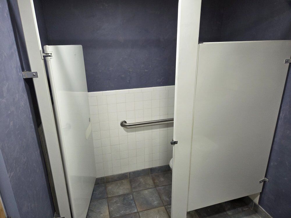 Bathroom stall walls with doors.