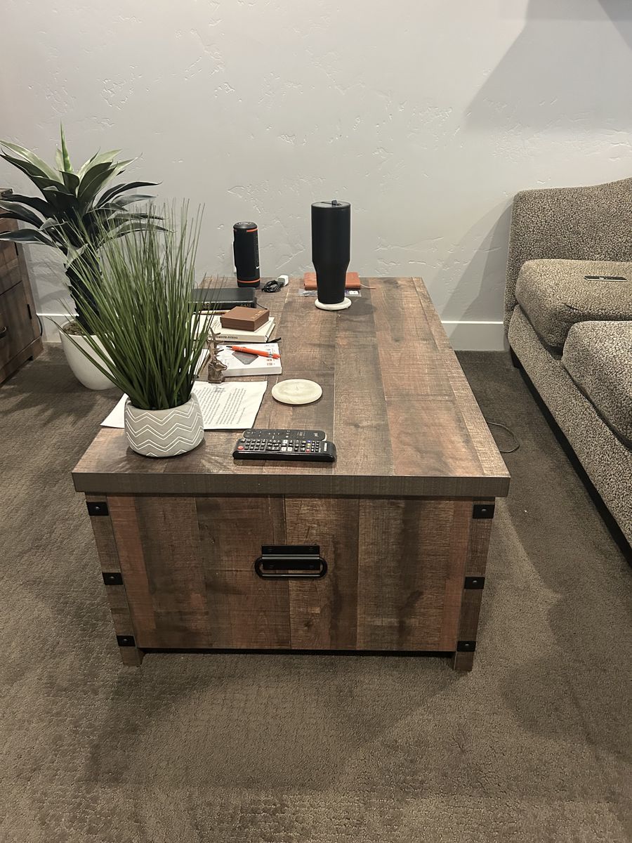 Coffee table with spring loaded lift top and interior storage
