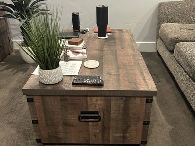 Coffee table with spring loaded lift top and interior storage