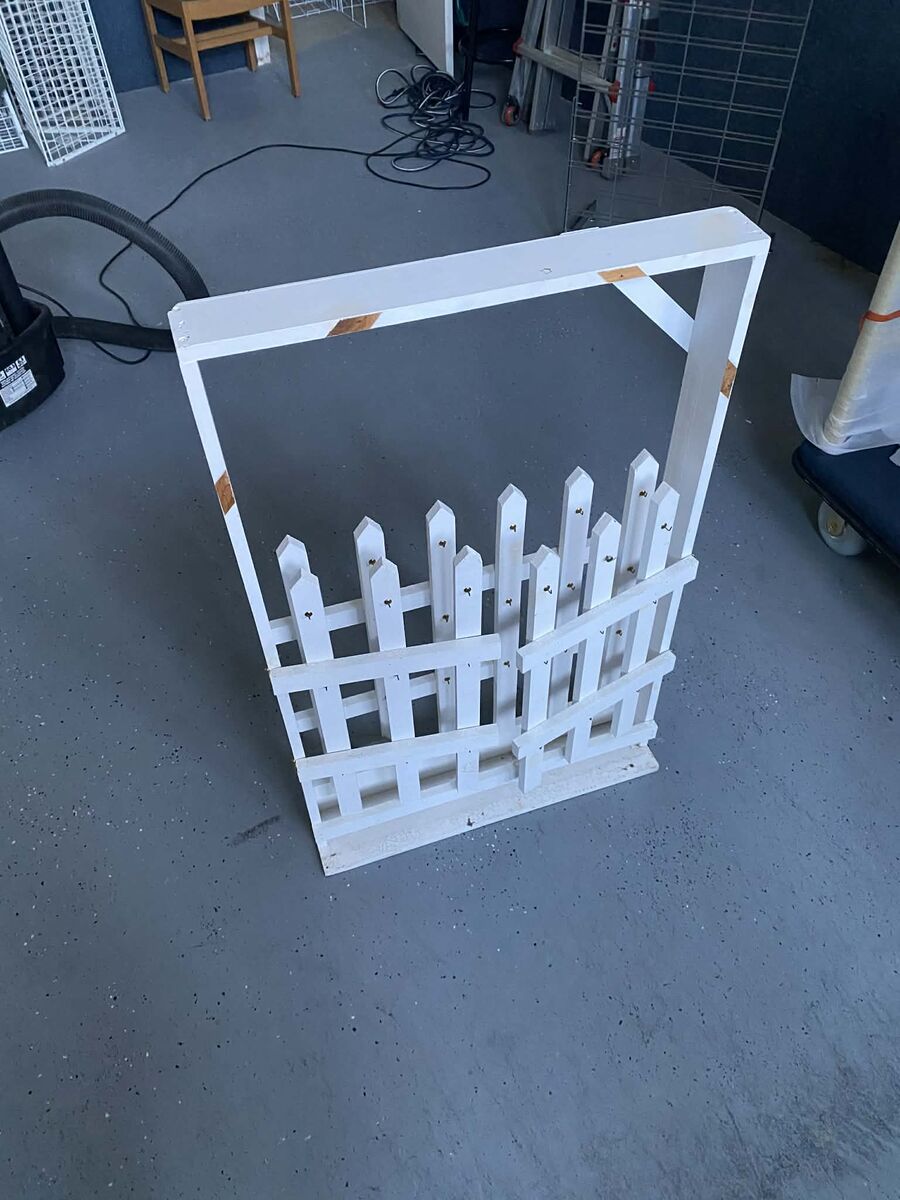 White fence/ It was used to hange lasting impression templates on, but can be used for other things.