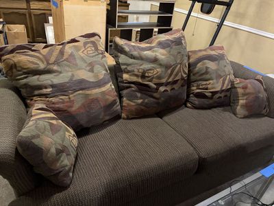 Brown Fabric Couch with Multicolored Patterned Throw Pillows and matching loveseat
