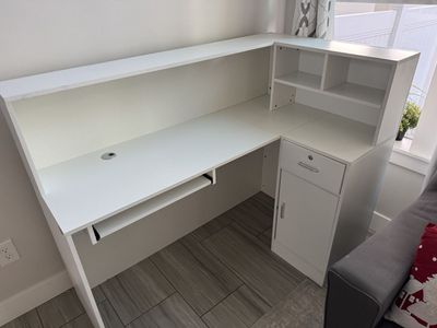 White L-Shaped Reception Desk with Storage Cubbies and Locking Drawer