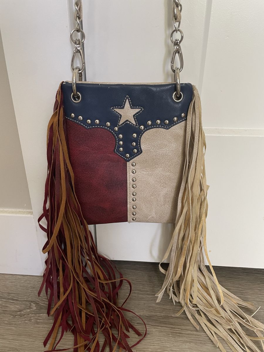 Chic Bag crossbody handbag features a Texas flag design with a star embellishment and long fringe
