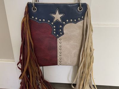 Chic Bag crossbody handbag features a Texas flag design with a star embellishment and long fringe
