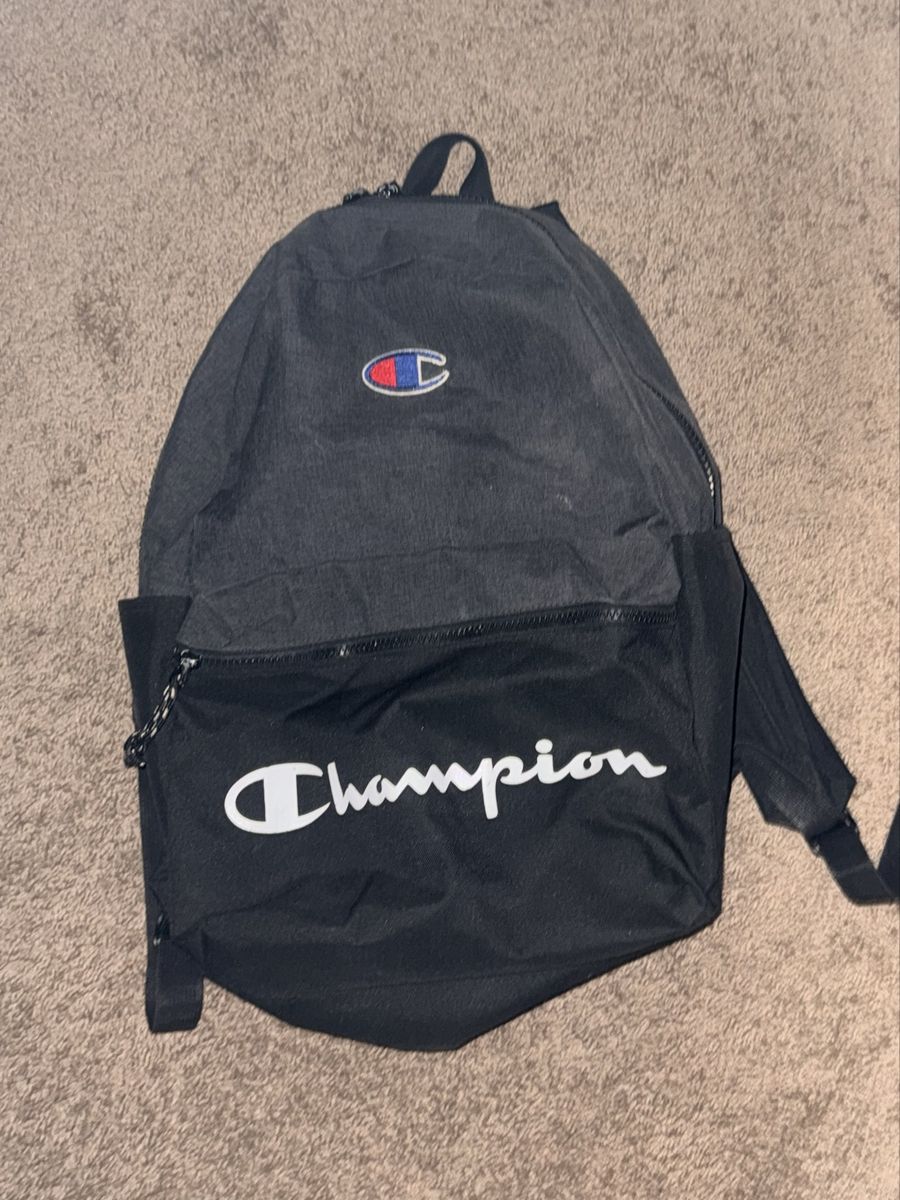 Champion Black and Gray Backpack with Front Script Logo on it 