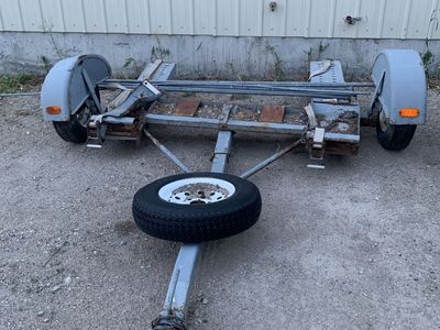 Two wheel pull behind car dolly, works great, but has a damaged fender