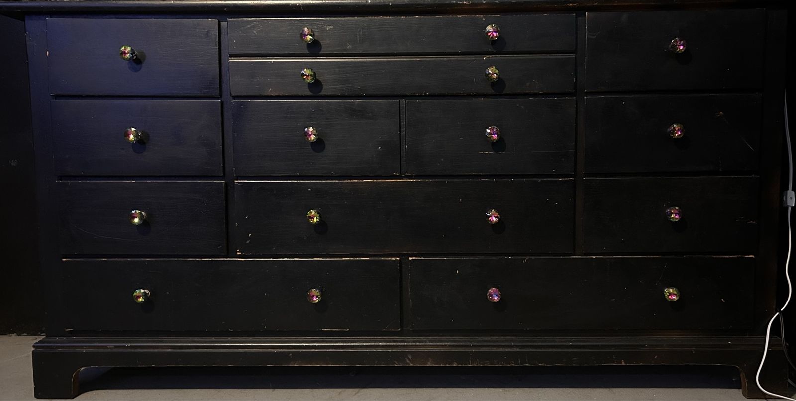 Black Wooden Dresser with Multiple Drawers and Decorative Knobs