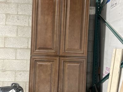 Tall Brown Wood Pantry Cabinet with Four Doors and Adjustable Shelves