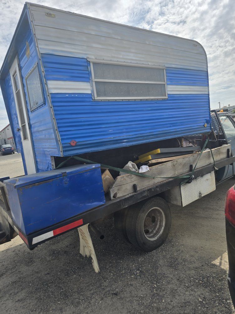 Vintage Blue and White Truck Camper with Interior Dining and Kitchen