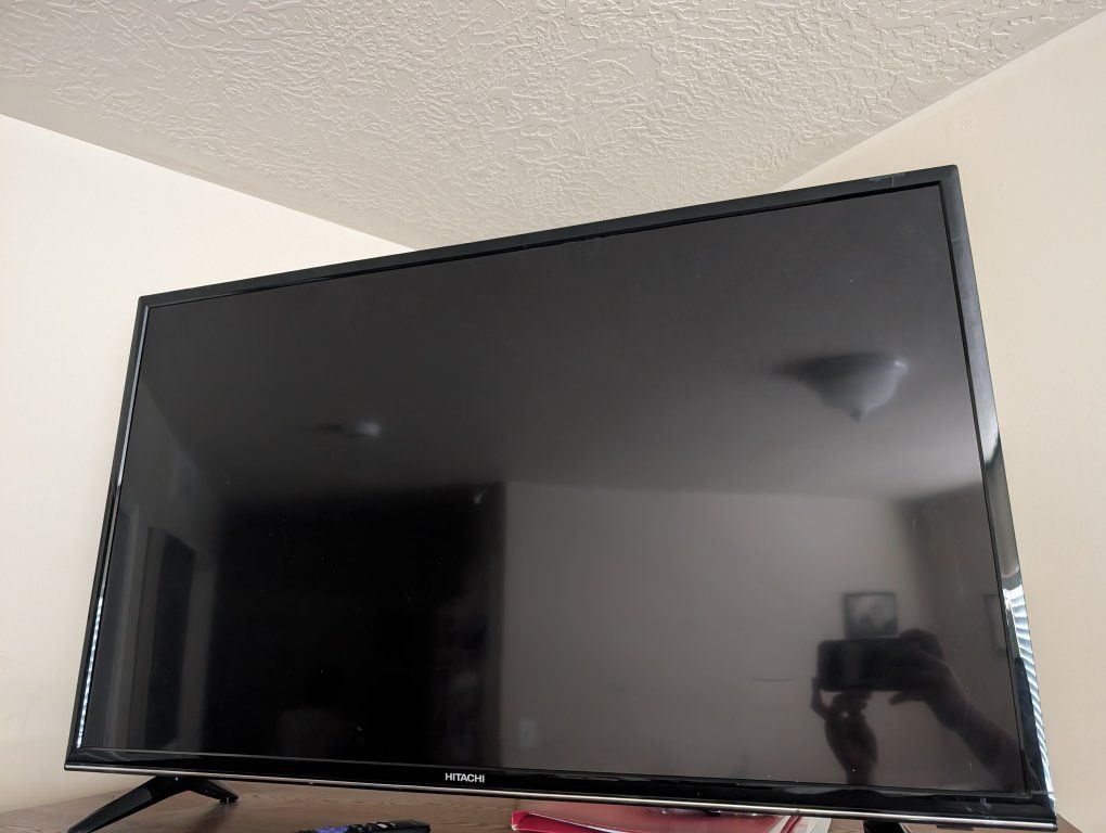 Hitachi Black Flat Screen TV - Used in guest room.
