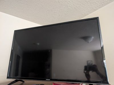 Hitachi Black Flat Screen TV - Used in guest room.