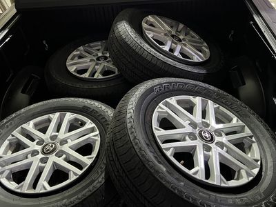 Set of 4 OEM Toyota 18” silver-painted alloy wheels with Bridgestone Dueler H/T tires (265/70R18 116T M+S)