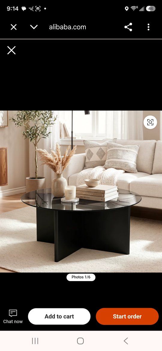 Modern Round Glass Coffee Table with brown legs.
