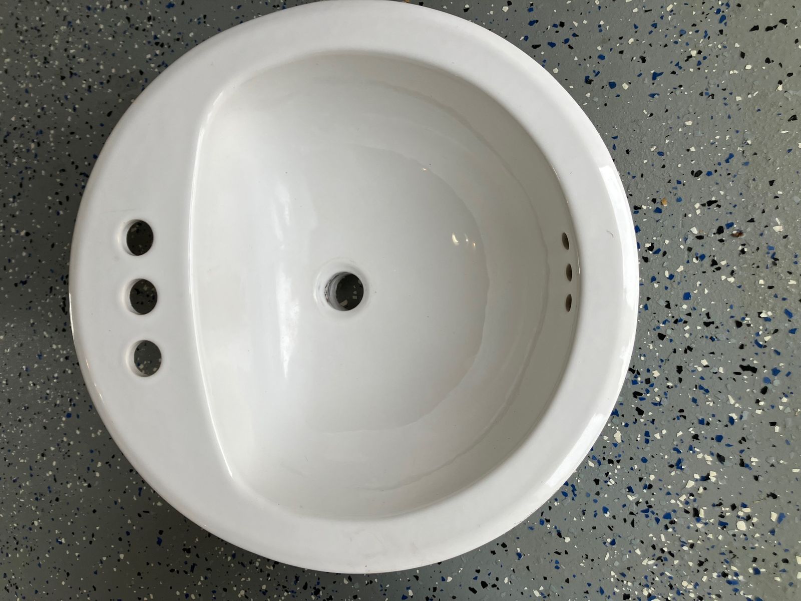 Two matching porcelain drop-in bathroom sinks