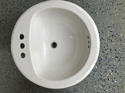 Two matching porcelain drop-in bathroom sinks