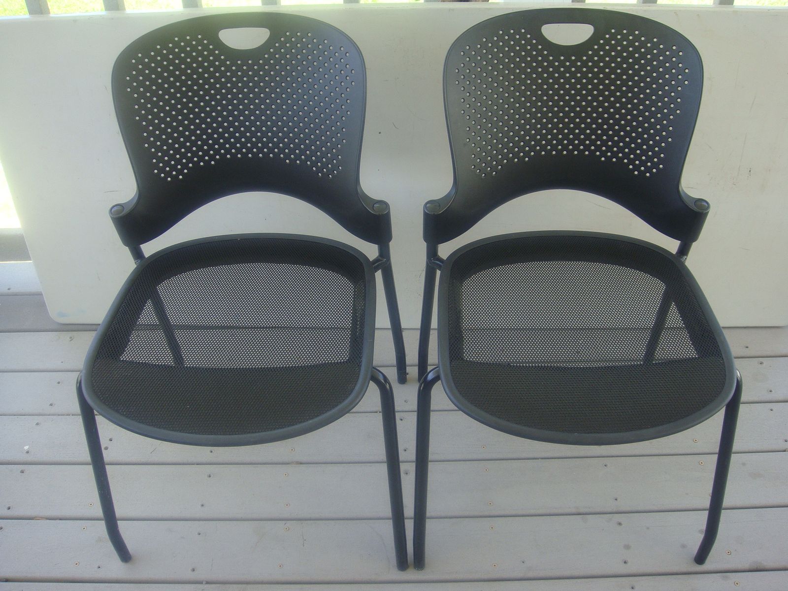 Set of two black Herman miller caper stacking chairs.