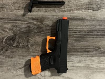 Glock 19 Gen3 CO2 Airsoft Pistol - SB199 Compliant with Orange Accents