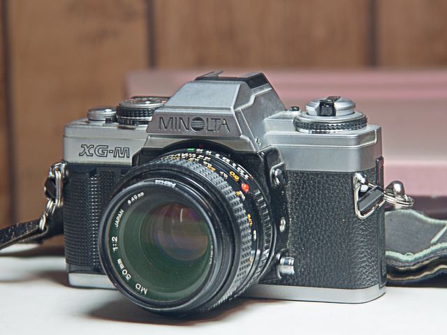 Minolta XG-M w/Minolta 50mm f/2 MD Lens (No Cap), Hoya UV Filter, Soft Minolta Strap.