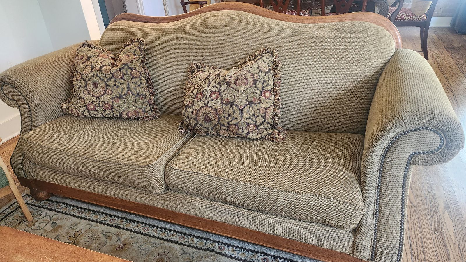 Traditional Upholstered Sofa with Wooden Trim and Accent Pillows with wood coffee table