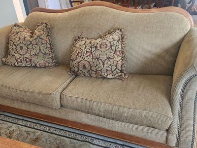 Traditional Upholstered Sofa with Wooden Trim and Accent Pillows with wood coffee table