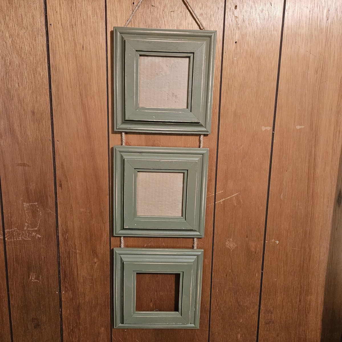 3 wood picture frames strung together with rope